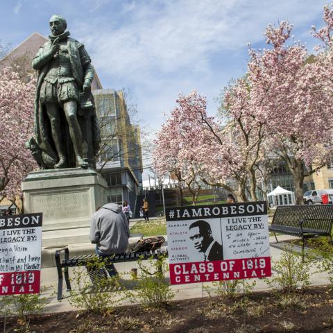 I Am Robeson signs in front of Willie the Silent status on Voorhees Mall