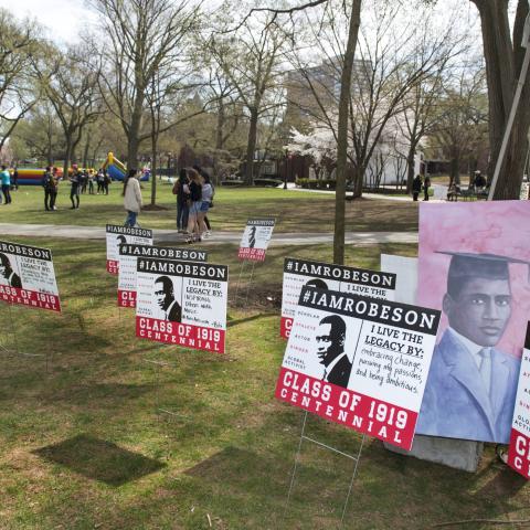 I Am Robeson signs in foreground with inflatable bounce house in background