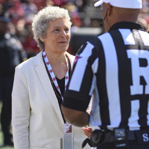 Susan Robeson speaks with game official